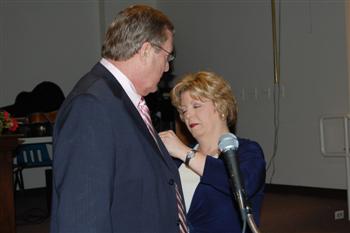 First Lady Beth Saunders pinning her husband Kentucky State President Vernon(Skip) Saunders. 