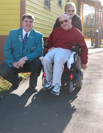 Larry and Marjorie Rice with Exalted Ruler Rich Taylor, on the repaved Driveway at the Rice's Partridge St. Home. The Members of Elmira Lodge #62 provided to have the age damaged driveway repaved, for this fellow member with Cerebral Palsy. Photo taken November 2009 by Mike Royle.
