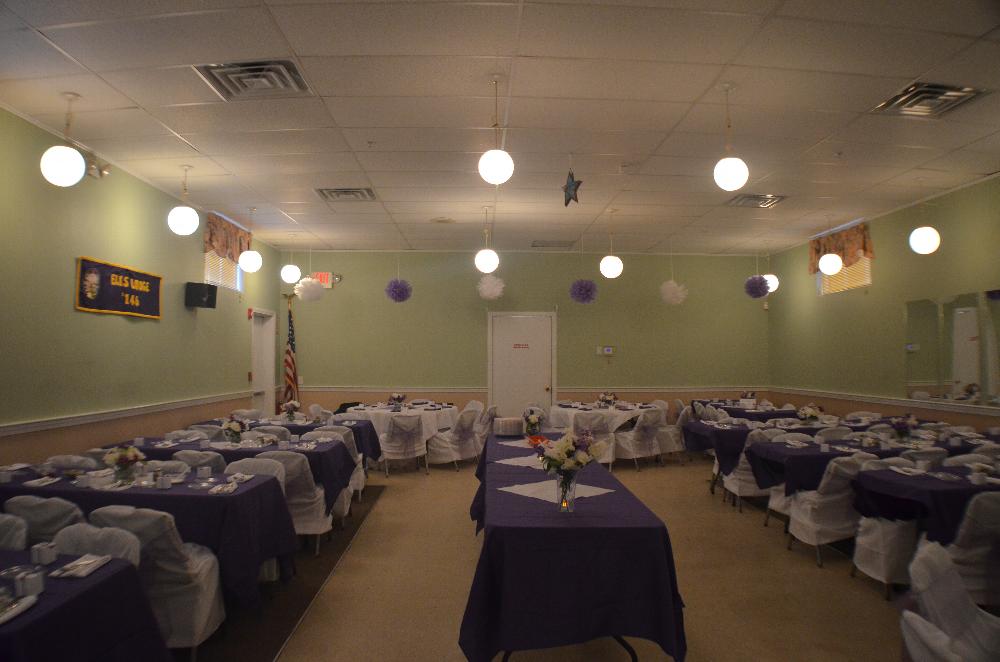 Hall decorated showing the tablecloths and chair covers available for rent for your event.