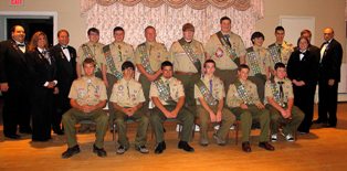 Pictured Above (L-R) with 13 of the 16 newest Eagle Scouts, are Taunton Lodge of Elks #150 Officers Paul Giannakoulis PER, Leading Knight, Sherry Davis Secretary and Lee Davis Exalted Ruler, Nicole Dudley Loyal Knight, Christopher Dudley Lecturing Knight and Joe Masterson, Past Lodge Trustee.