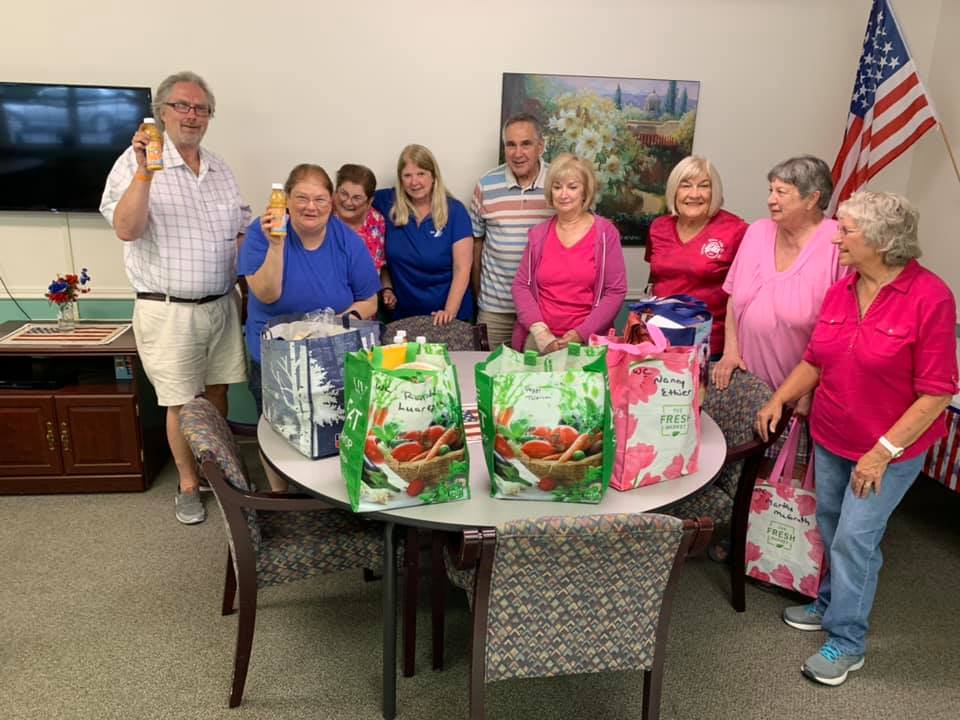 Senior Outreach Committee Delivering bags of food to Seniors - Impact Grant