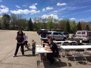 Oak Park Heights Officers providing safety information at Stillwater Elks May 1st Bicycle Saftey and Tune-up Event. 