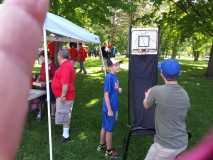 Kids playing with basketball hoop-shoot basket down at Owen Park during the parade.