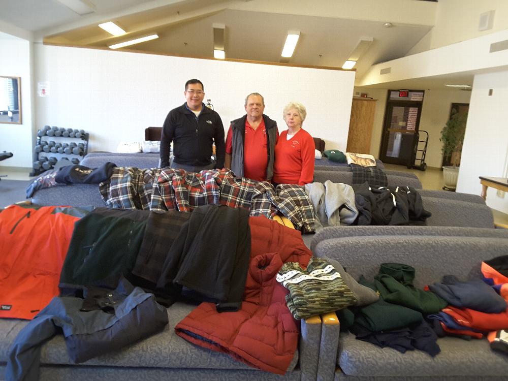 George and Muriel with clothing contributions laid out for the residents to inspect and select.