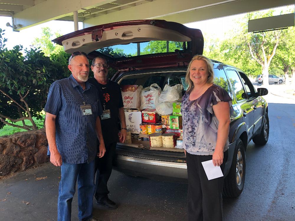 Steve & Steve from Good News Rescue Mission getting a check and food from ER Malinda Hutchison dureing Redding Elk Lodge 1073's Food Drive to replenish local food banks during Covid-19
