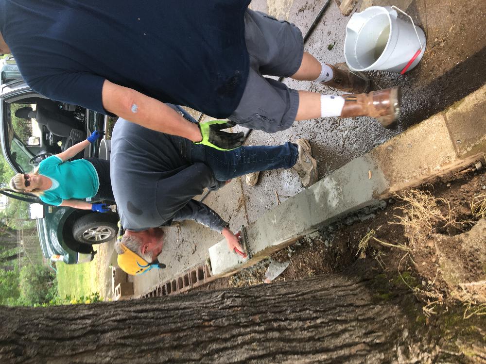 Elky-Doers repairing the block wall on the path to the river trail. Jodi & Pat Stone and Trustee Jim Schlueter