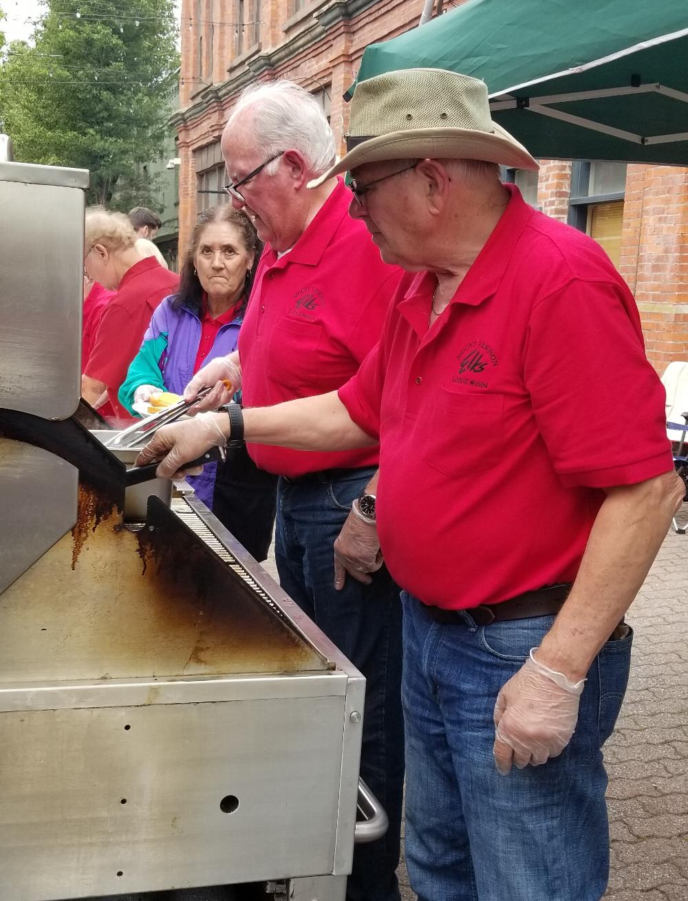 Don Hammond and Ed Anderson cooking up some Hamburgers
