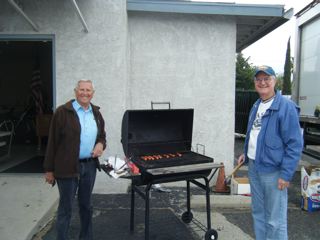 Don Laundreaux and Brian Morrissey  cooking hot dogs for the Kids Easter Egg Hunt