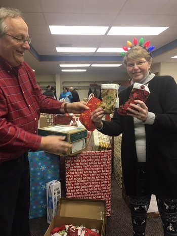 Jerry Wattier (left) is the chairman of the Pierre Elks Lodge's successful Stocking Stuffer Program.  He's joined here by Lodge Chaplain Karen Van Mullem on December 15, 2018.  They're showing some gifts for veterans provided by the Pierre Women's Club. 