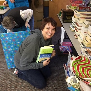 Pierre Elks Lodge Inner Guard Heather Perry, sorting books for the Stocking Stuffer Program on December 15, 2018.