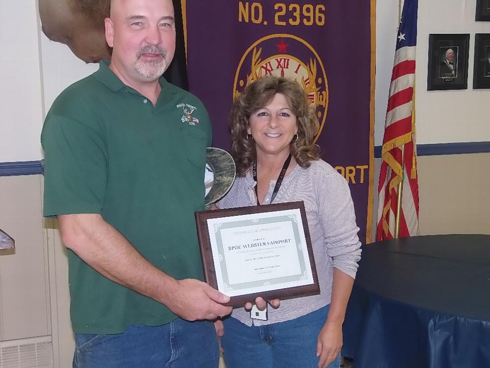 PER Bob Snover accepts recognition certificate from Lucy Olsen, VA Coordinator, for the Webster-Fairport Elks service to the VA Hospital