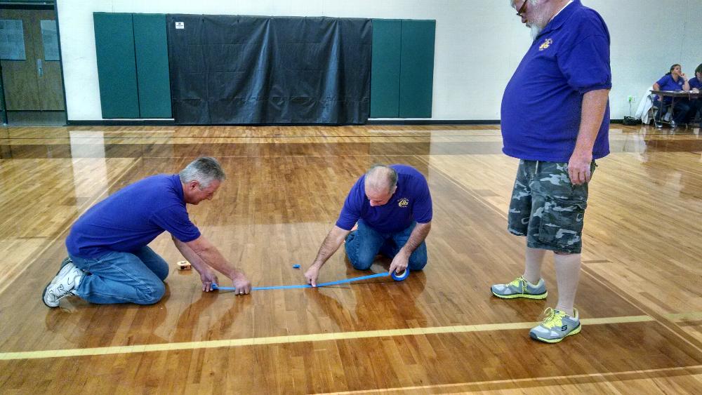 Brad Warwick, PER, Pete Gonzales, and Jim Prentice, PER measure out the lines for Hoop Shoot competitors.