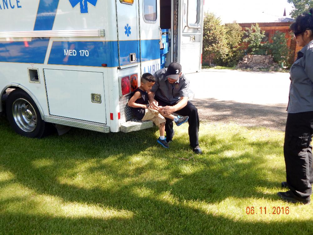 EMS helps put a band-aid on a little boy.