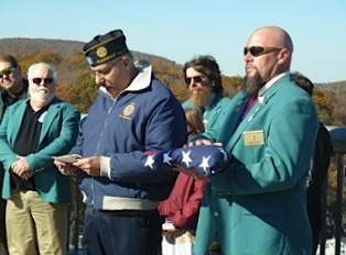 ER Jamie Depuy receives the Flag as American Legion Commander from Pleasant Valley NY recites the retirement ceremony.