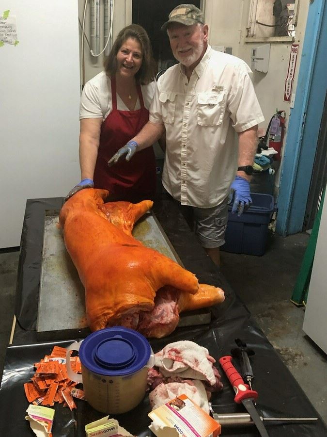 Tom and Lisa Anderson prepping the pig for a great Spring event!