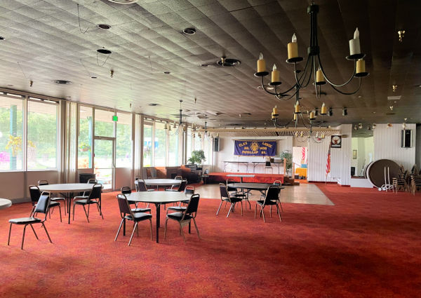 Meeting room with round tables, large windows, stage