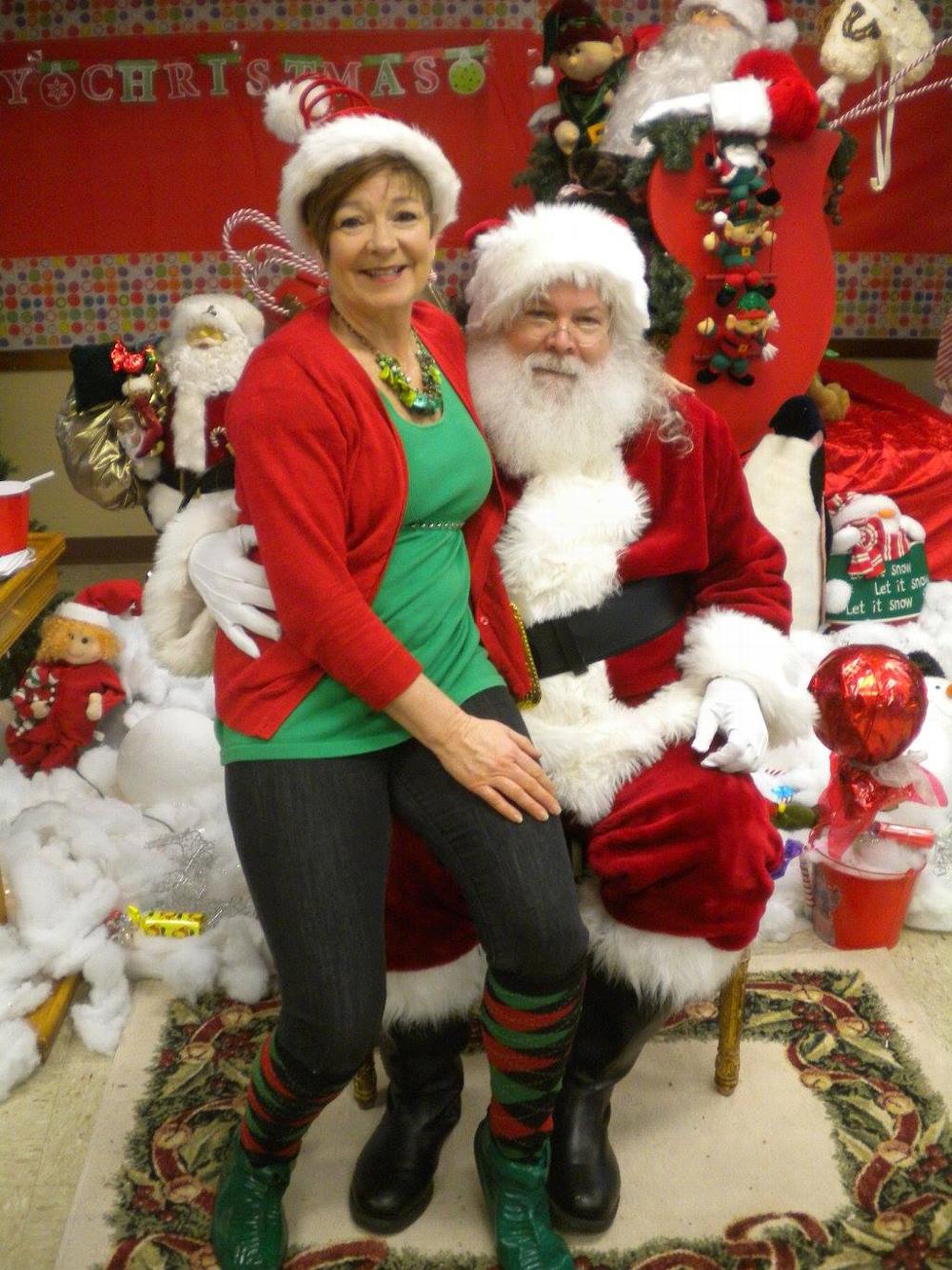 Elf Luanne Cummings with Santa.