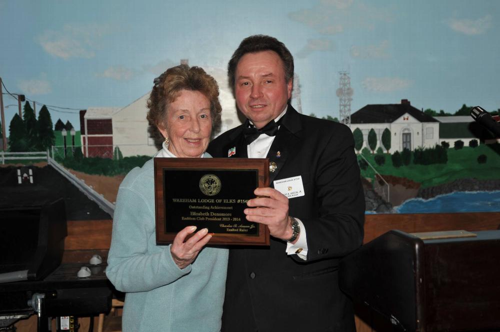 A plaque for Elizabeth Densmore Emblem Club President 2013-14 accepted on behalf is MO. and Chuck Anson.
