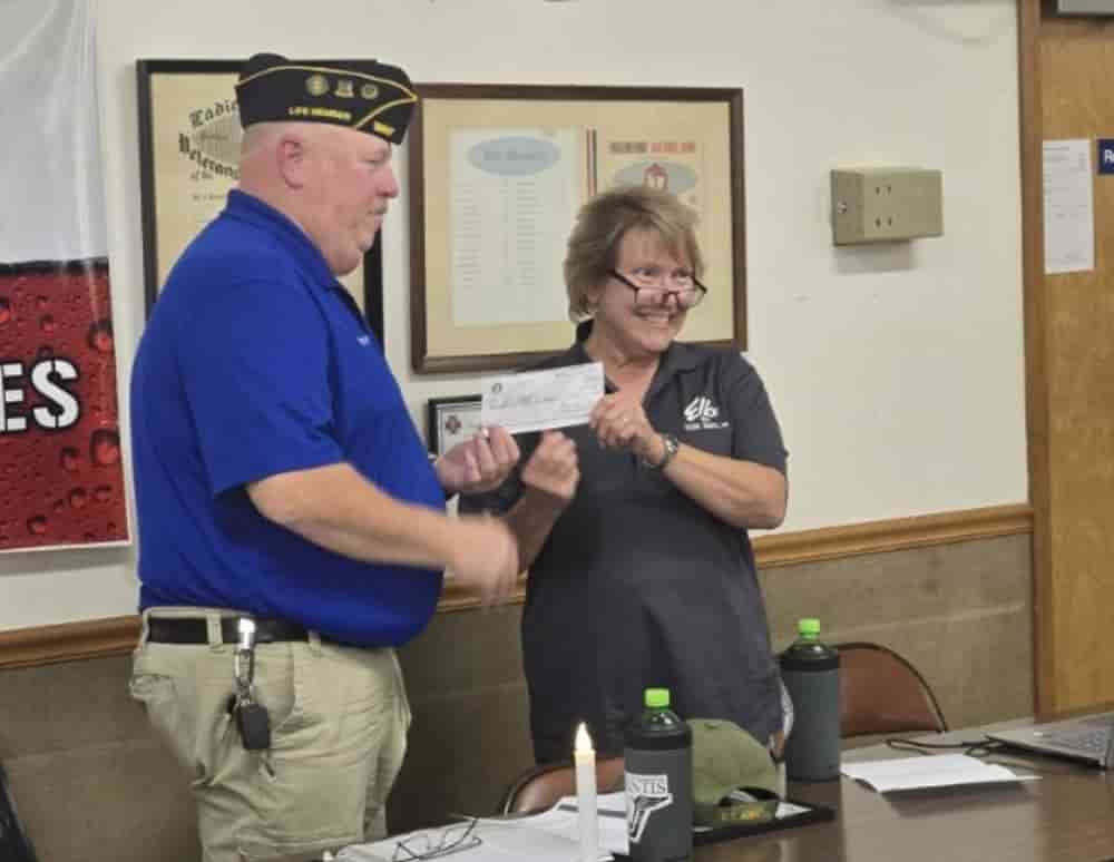 Elk Christine Davies presenting a check to DAV for the Hog Roast.