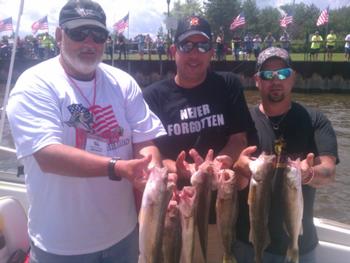 A group of Vets with a great catch in the Walleyes for Warriors aboard the Heat Wave