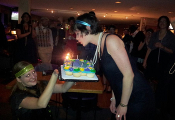Celeste blowing out the candles on her birthday cake with Brittany's help...and some help that was!