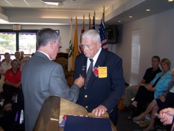 State Association President Oren Richardson Presenting Earl G Schweizer wiuth his 75 year member pin.