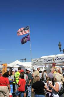 The American flag and the Elks flag proudly flying at the 13th Annual BBQ on the River.  The Elk's Cajun Corn booth is located in a prime spot...in the middle of all of the action.