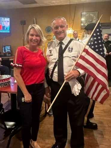 True Americanism was on full display at the Jacksonville Elks Lodge 221 Flag Day Ceremony.
The lodge opened with the Pledge of Allegiance and God Bless America. Honorable Bob Morgan officiated the Elks Flag Day Ritual. 

Lodge Officers, members, family, armed forces, veterans, police officers and representatives from Concerns of Police Survivors (C.O.P.S.) were present to pay their respect to Old Glory. About Our Flag Brochures, Honor Our Flag Decals and flag lapel pins were passed out as a reminder America is Freedom. 

Congratulations to Wally Banks JSO Police Officer for winning the free 3x5 United States of America Flag Giveaway.  The ceremony was followed by a fireside burning of 52 unserviceable flags and the lodge hosted a buffet for all who were in attendance.  
Americanism Chair Carla Rhymes pictured with Wally Banks of the JSO.