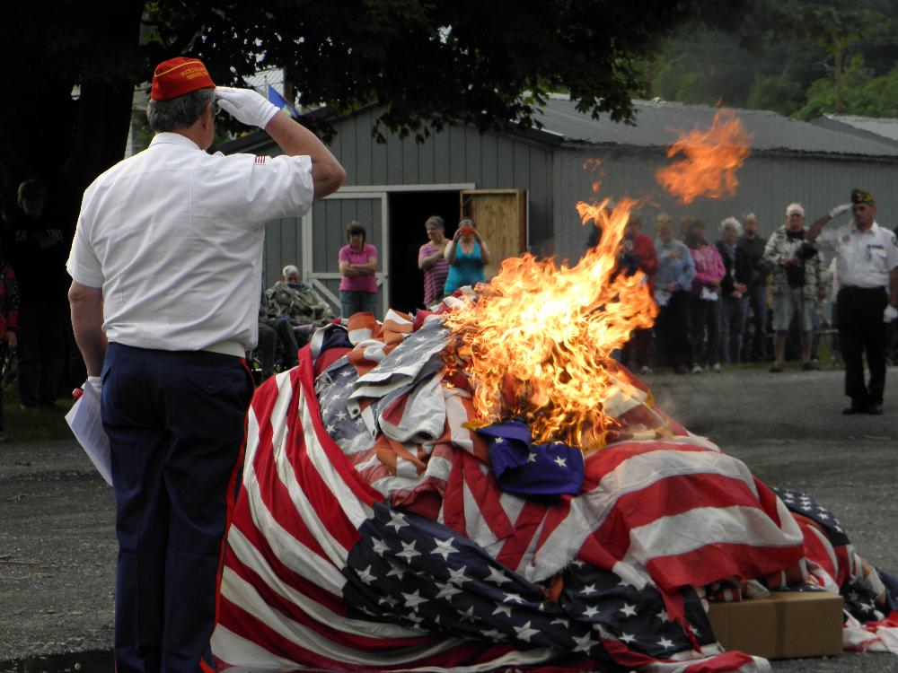 Ron Jones (Lodge Member & Marine Corps League member of Bucktail Detachment #856) renders a final salute to unserviceable flags.