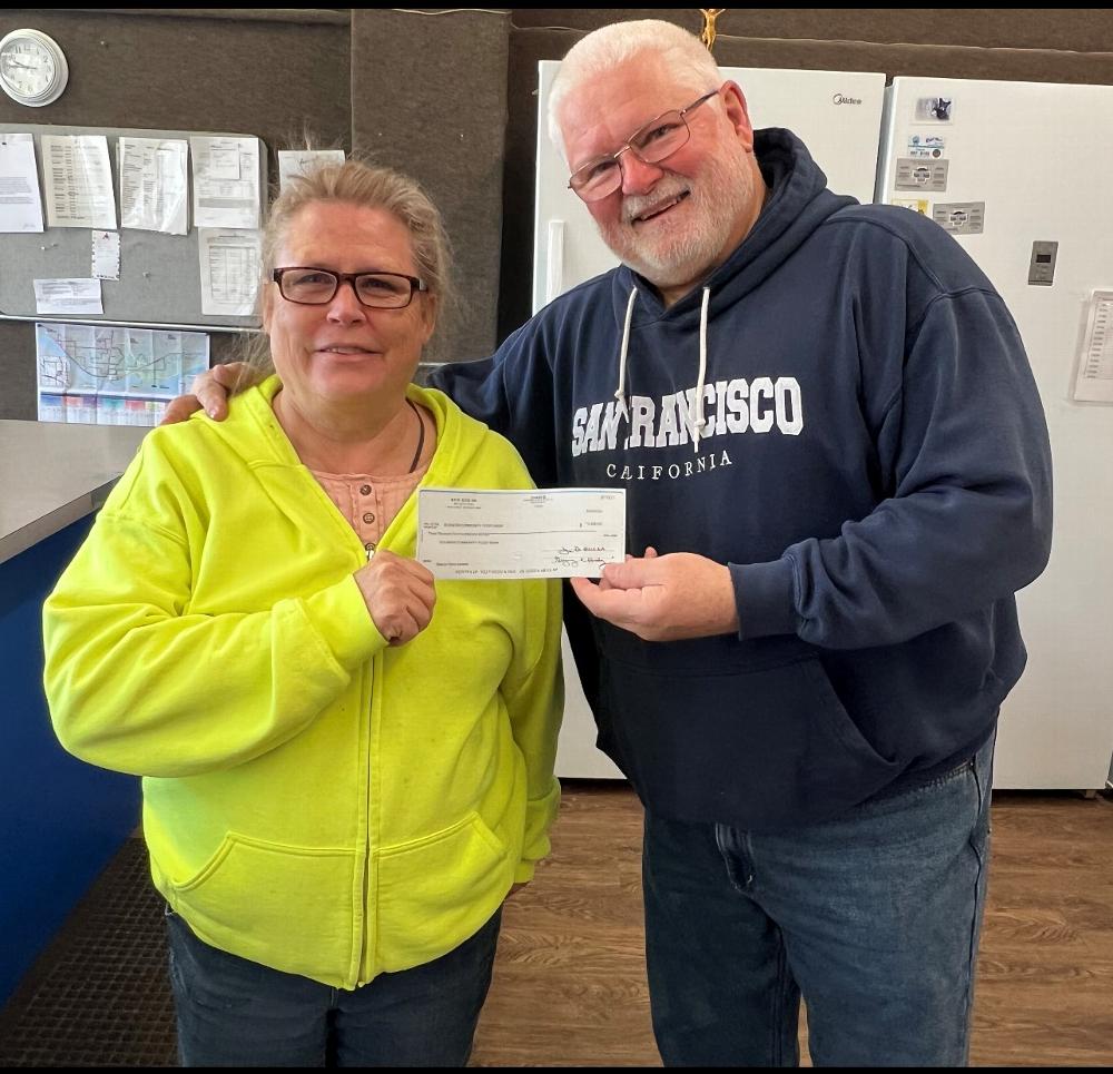 Presenting the 2022 ENF Beacon Grant check to Janine Dionne is PER Scott R. Harris