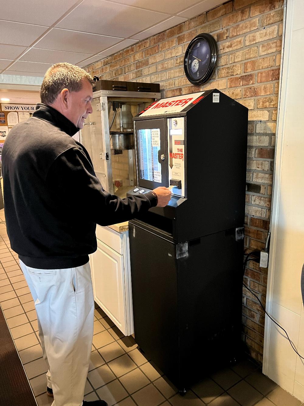 Elks Lodge 343 Golf Pro Brian Bowman  buys first tickets from new PER Association Pull Tab machine