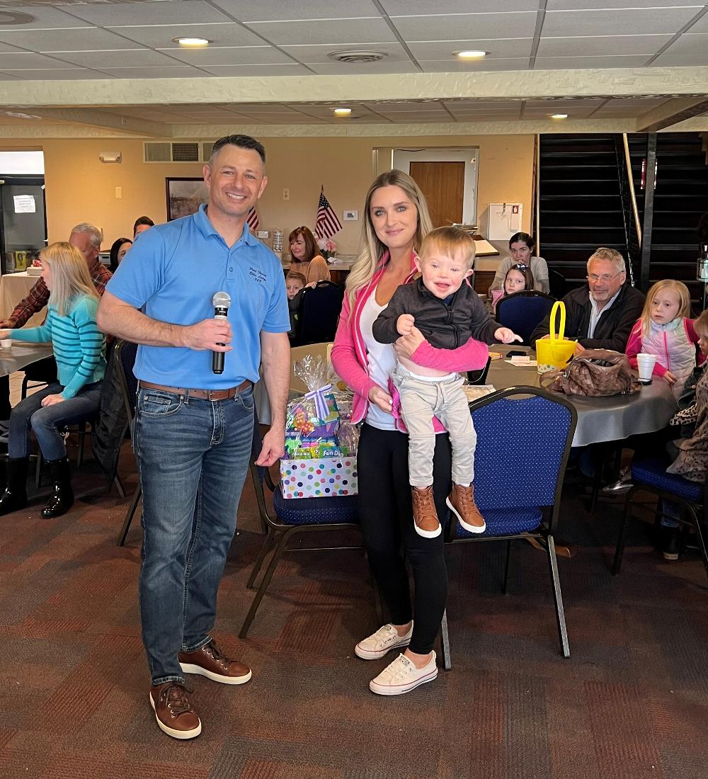 Marty Prevost present Hilary & Hudson Clark the Grand Prize from the 2022 Easter Egg Hunt Raffle