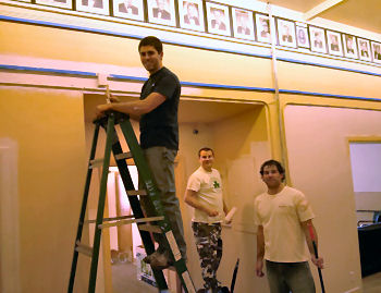 PERs look on as three of our volunteers prime the walls in the Members Bar. 