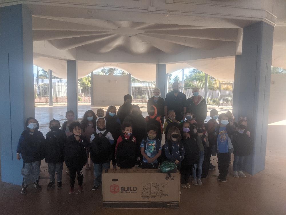 Distributed 25 bicycles, 25 backpacks with school supplies and $75 gift cards to 25 students at Walter Douglas elementary school on December 13, 2021. In photo: Leading Knight-Susan Trecartin, PER-Bob Holyoak and ER-Wayne Burns.