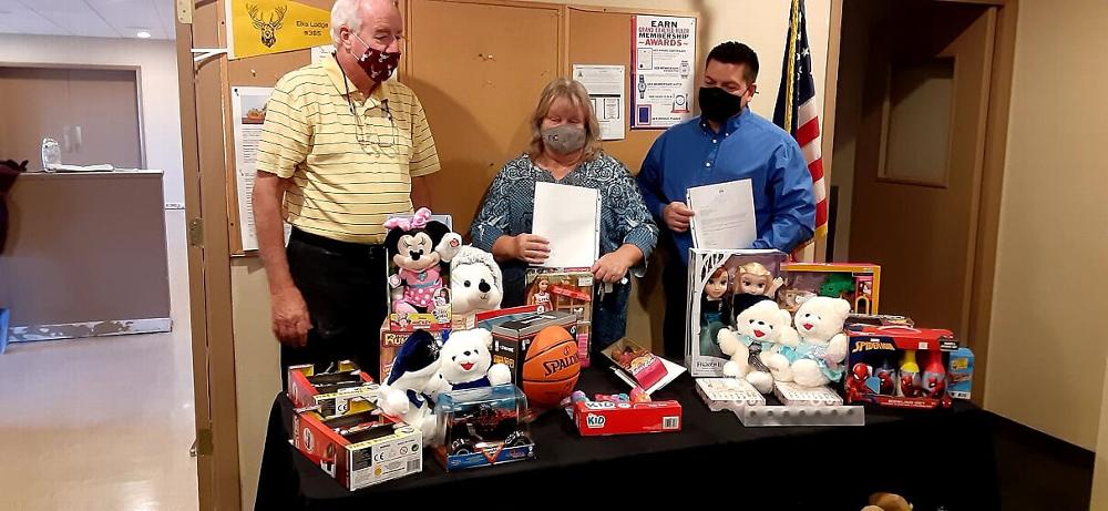 Tucson Elks Lodge #385 members donated several children holiday gifts to Southern AZ Family Involvement Center, a non-profit organization which assist local Tucson families in need. Pictured L-R, BOD Chairman/Leading Knight W. Burns, Southern Regional Director P. Grant, Program Development Manager, E. Casillas.  12-15-2020