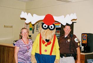 Activities chairman Jane Berggren, PER, Elroy the Elk, and a local sheriff's deputy pose for a picture at the 2010 Kids Fun and Bike Safety Night hosted at the lodge
