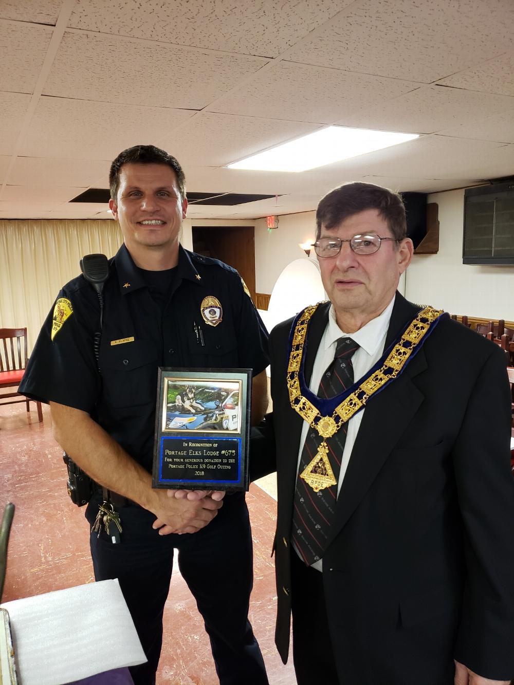 Portage Police, Keith Klafke presented        ER H. Paul O'Brion with a plaque for the donation Portage Elks Lodge #675 gave to the K9 golf outing  