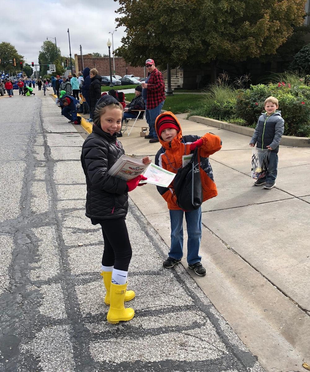 Addy Tapscott, daughter of PER Luke Tapscott, passing out Drug Awareness coloring books at the Illinois College homecoming parade. 