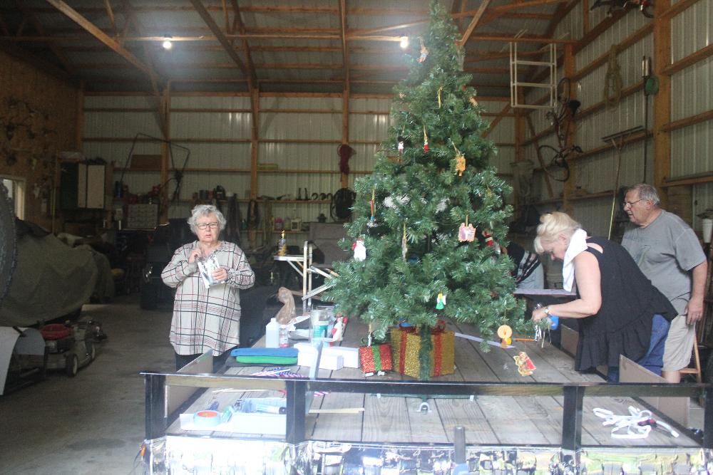 Donna Smrz, Joy and Pete Rogoski working on float 2021.