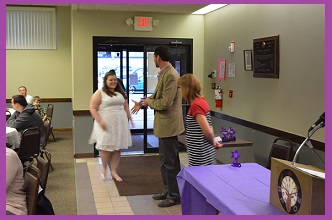 Mayor Tobin congratulates a student winner while her teacher looks on.