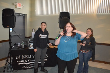 Jen and Carrie and Carrie preparing to sing a song. While Cortland High School Link Student wonders when they will hand her the microphone.