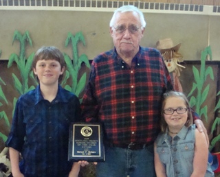 Mike McGuire, with his two grandchildren after he receives "Senior of the Year Award."  Mike is a perfect example of "Elks Share, Elks Care."