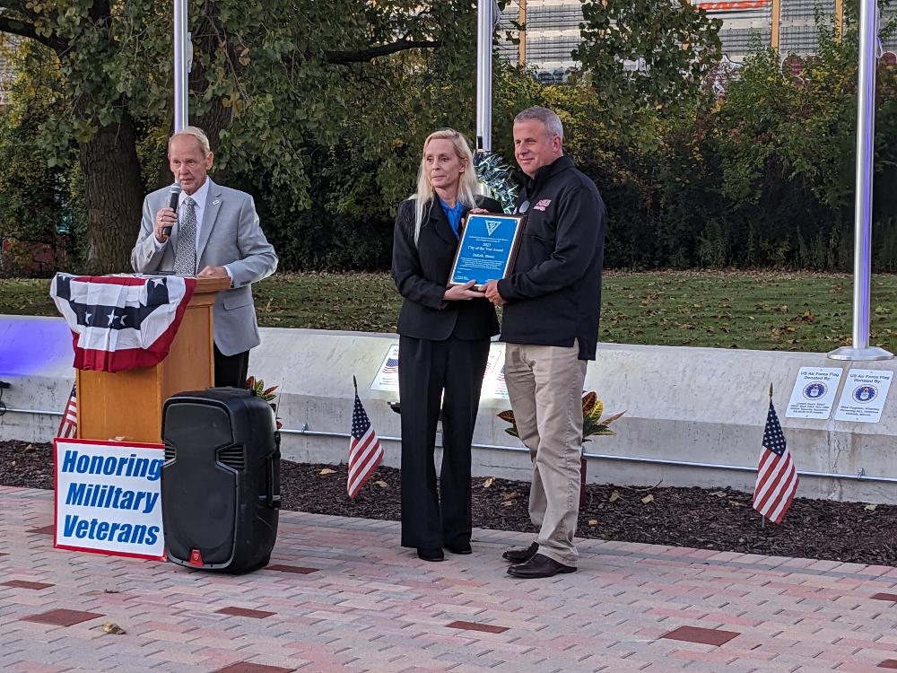 Michael Embrey making the announcement that the City of DeKalb received the award of  National Veterans Friendly City of the Year award for 2023. Mayor Cohen Barnes receiving the award from Celeste Latham, Commander of the 40 & 8 for DeKalb County. 