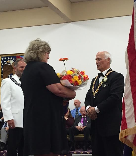 Incoming Exalted Ruler Mark Violante presenting flowers to incoming First Lady Karan Violante. -April 2016