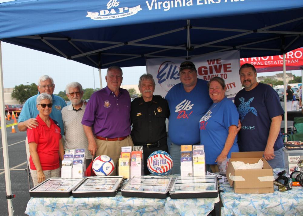 Fredericksburg Elks Lodge #875 came out in force for the 40th Annual National Night Out.  Spotsylvania County Sheriff Roger Harris stopped by and chatted with the volunteers and thanked them for coming out to be a part of the event.  The lodge distributed the newest information from our DAP, coloring books, and used our impaired vision goggles to show the effects of drinking or drugs by letting participants try to walk a straight line heel to toe or throw cornhole bags at a cornhole board.  This was the biggest crowd in the last few years as roughly 1000 parents and children were at the event.  

Picture (L to R) Previous Virginia First Lady Elizabeth Dameron, PVSP and Trustee Ray Dameron, Harold Marciari, PGER Ron Hicks, Sheriff Roger Harris, PER and Trustee Linnie Lee Baker, Tiler Lisa Baker, Esteemed Loyal Knight Steven Levinsohn