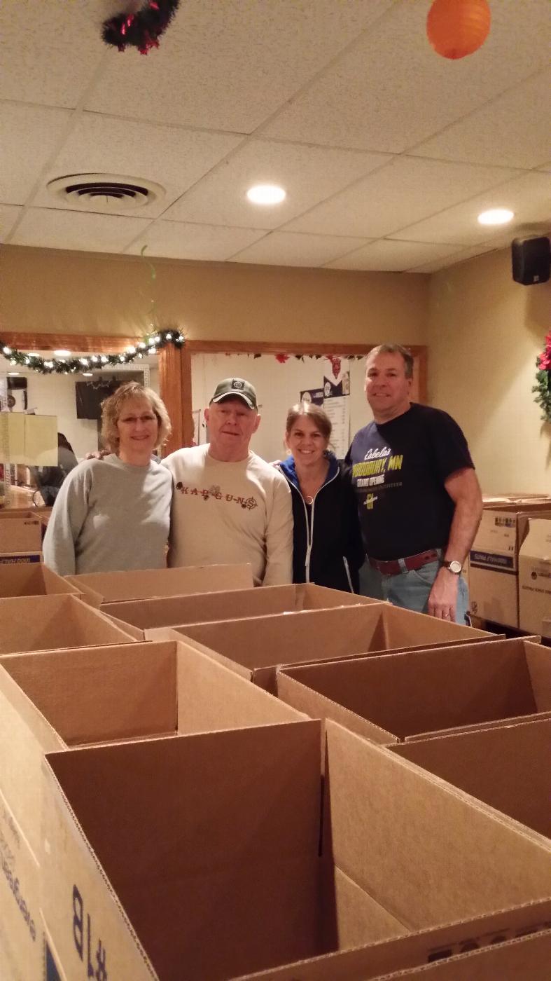 Marcia & Ken and Julie & Marty oversee the boxes.