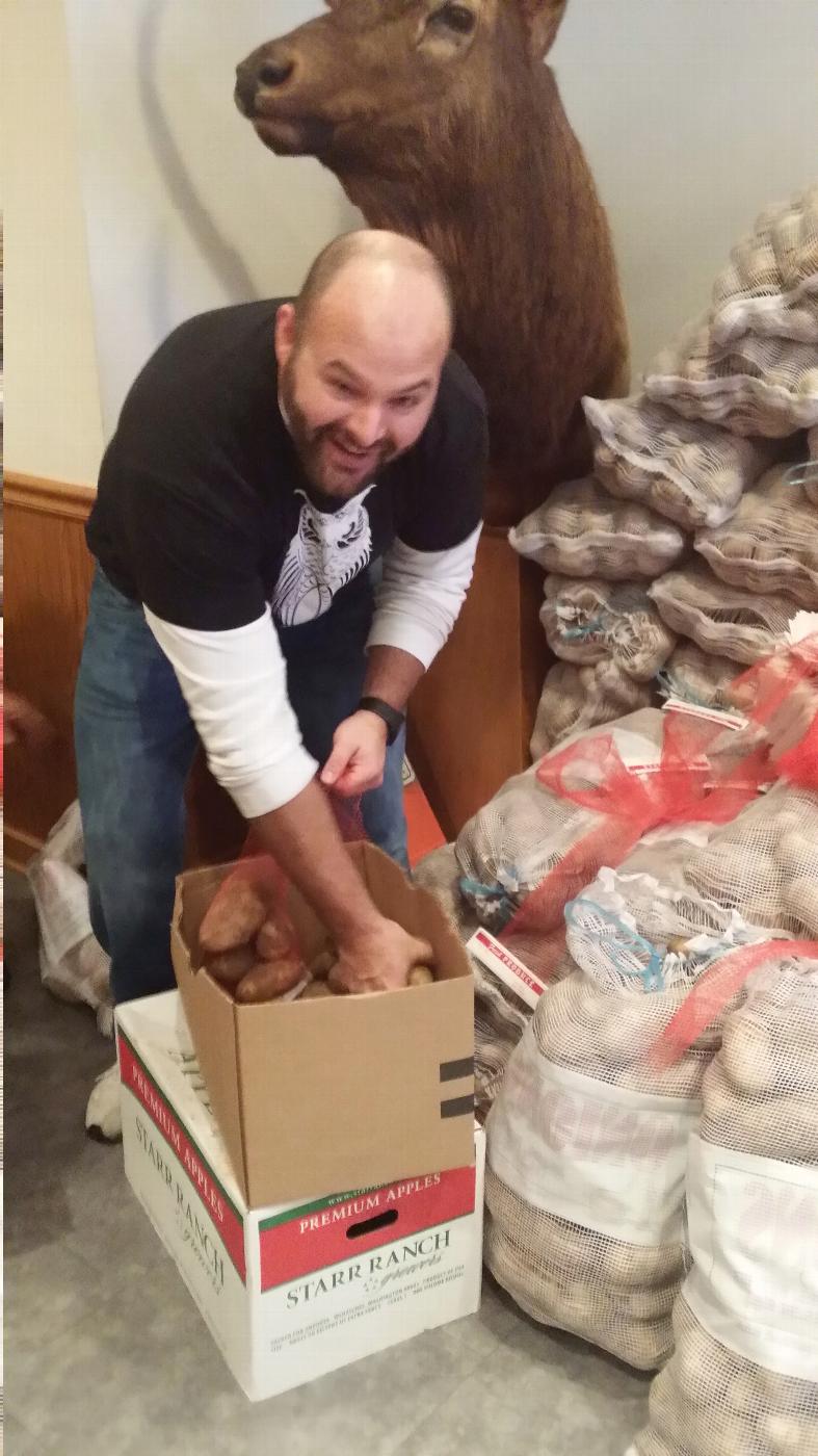 Loyal Knight Nate packing potatoes under the watchful eye of Edward the Magnificent Elk.