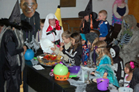 Kids help "Witch" Alicia make her brew at the children's Halloween Party.