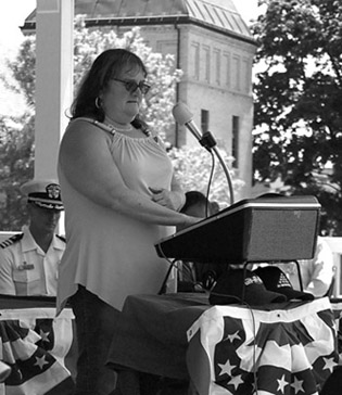 May 2012: Veteran's committee chair Debbie Irish joins the annual Bath Memorial Day ceremony, honoring the name of every American serviceman lost during the previous year.