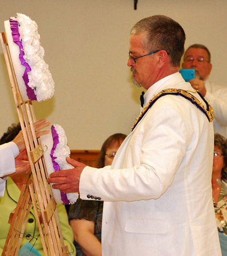 2014-15 Exalted Ruler Clifton Given II hangs the wreath in remembrance of Bath's lost members during the Maine State Elks Association convention, 2014.